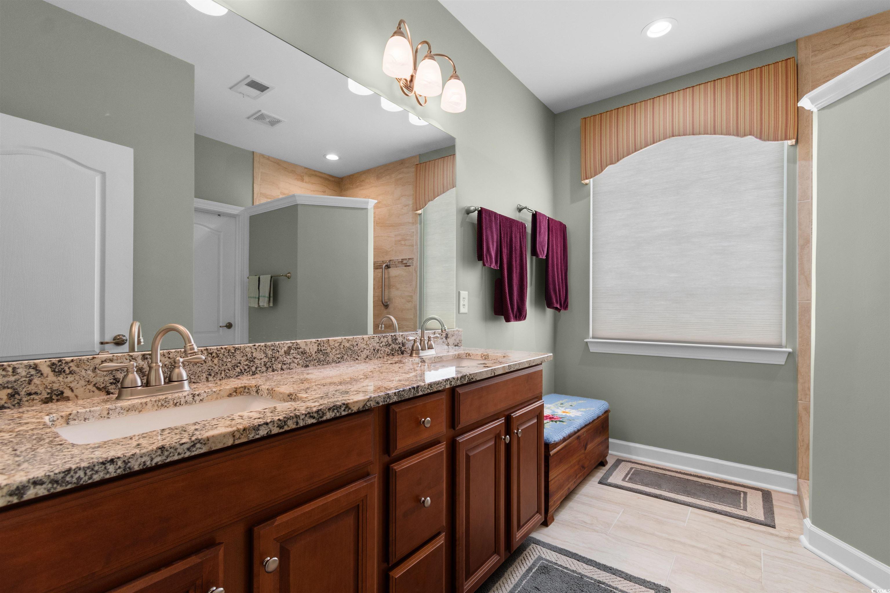 1573 Culbertson Avenue Myrtle Beach, SC 29577 - Photo 17 of 40 Bathroom with double vanity, a stall shower, and recessed lighting