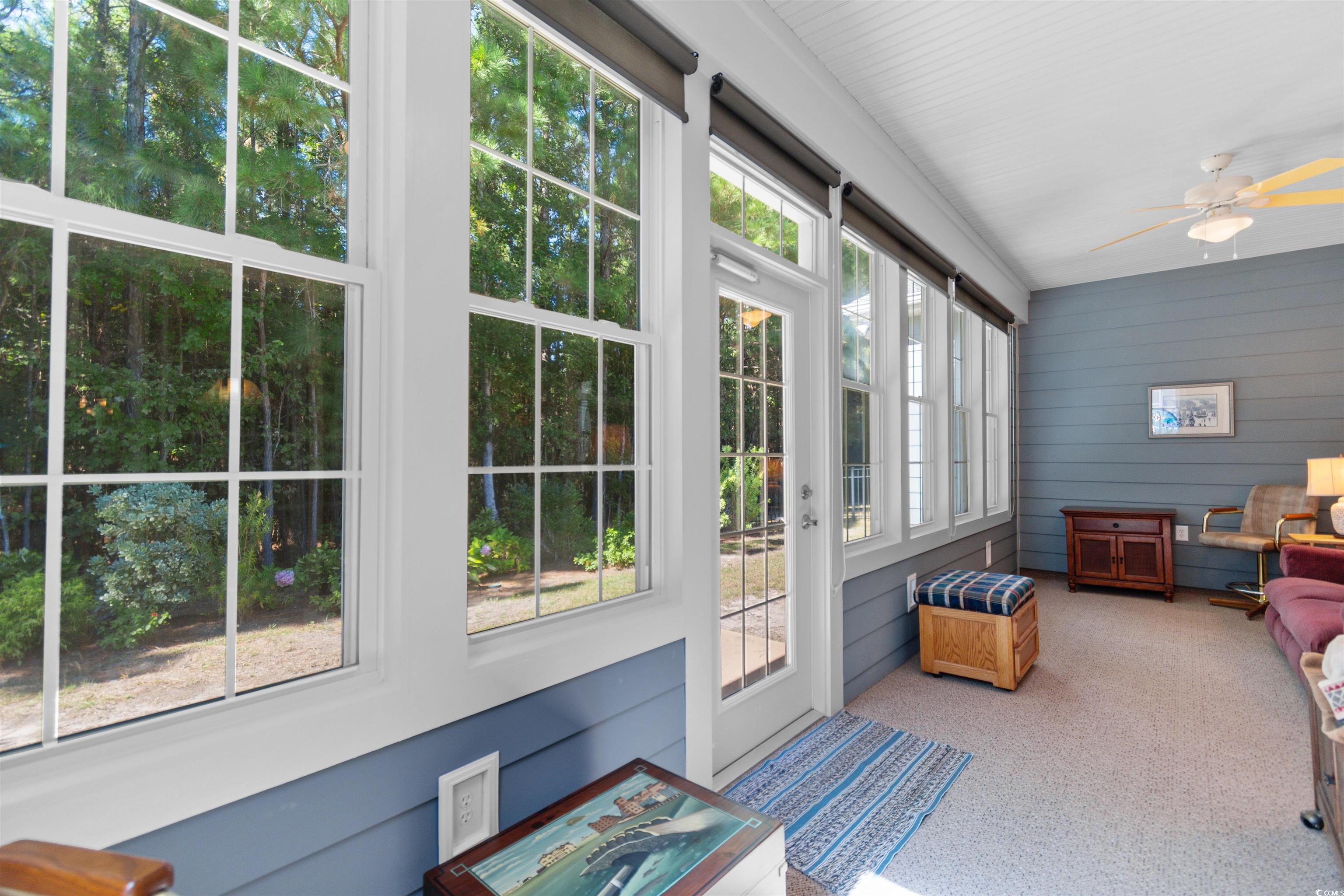 1573 Culbertson Avenue Myrtle Beach, SC 29577 - Photo 25 of 40 Sunroom / solarium with a ceiling fan, carpet, and wood walls