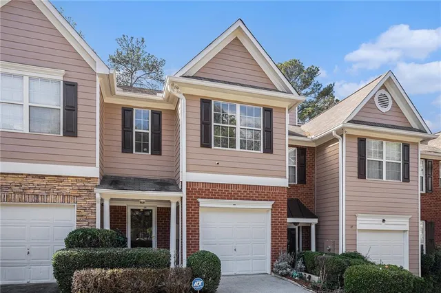 a front view of a house with a yard and outdoor seating