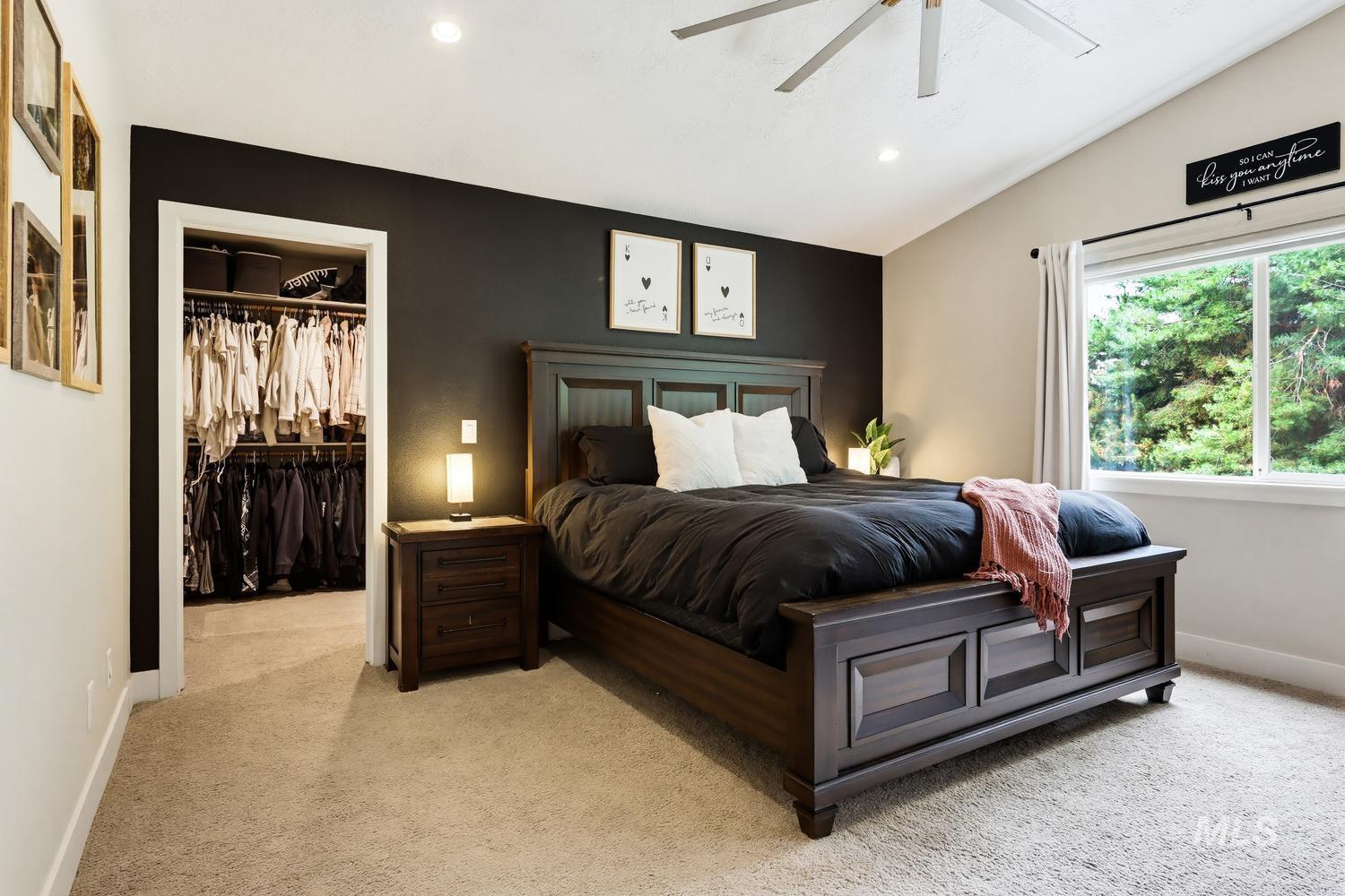 369 South Winthrop Way Boise, ID 83709 - Photo 26 of 50 Vaulted ceiling bedroom with a walk-in closet, recessed lighting, and a window overlooking mature trees