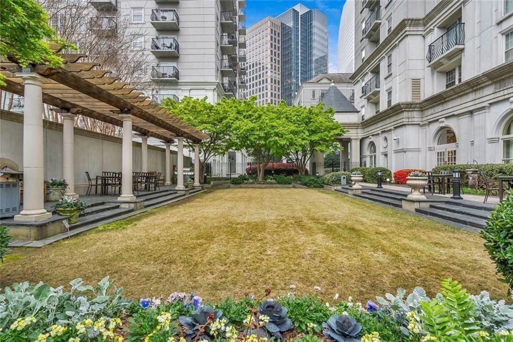 199 14th Street Northeast, Unit 510 Atlanta, GA 30309 - Photo 20 of 21 a swimming pool with outdoor seating and yard