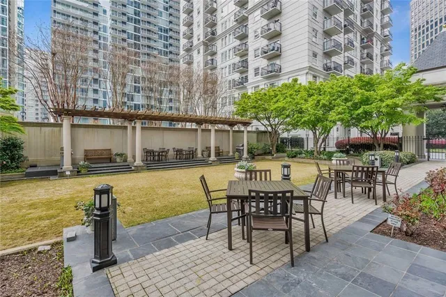 a swimming pool with outdoor seating and yard