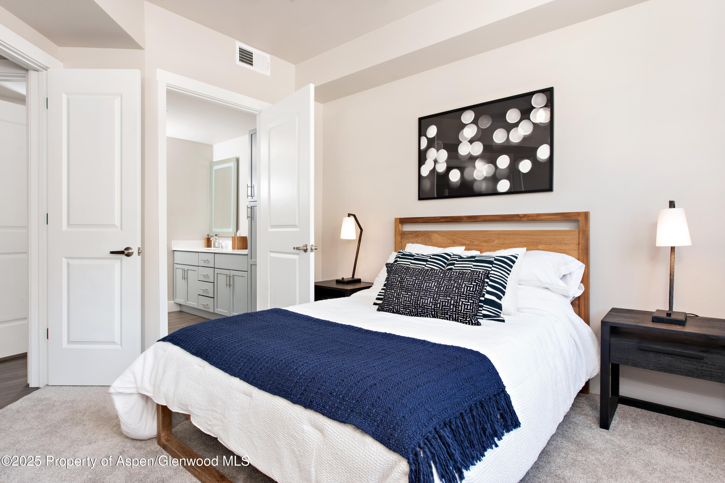 253 Wulfsohn Road, Unit 326 Glenwood Springs, CO 81601 - Photo 17 of 41 a bedroom with a bed and a painting on the wall