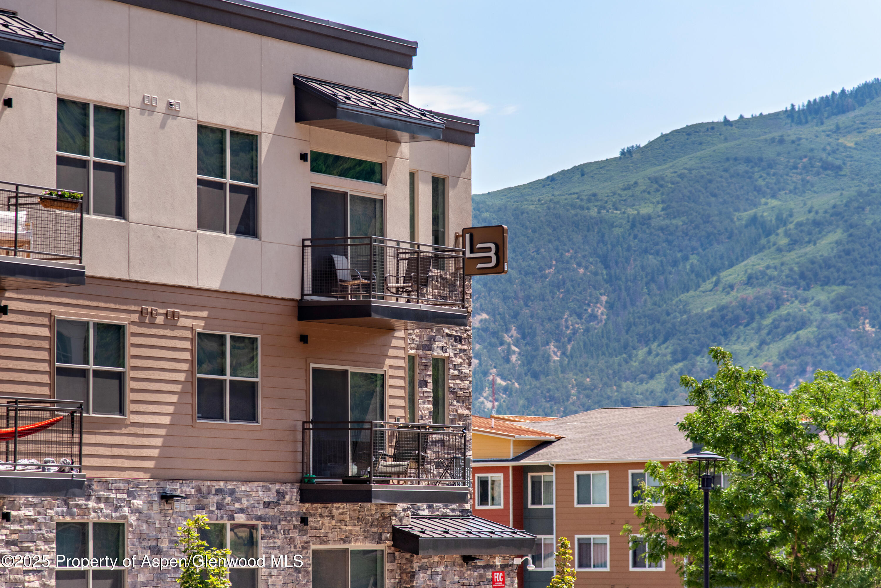 253 Wulfsohn Road, Unit 326 Glenwood Springs, CO 81601 - Photo 3 of 41 a front view of a building with a yard