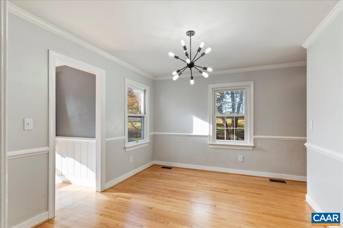 555 Gillums Ridge Road Charlottesville, VA 22903 - Photo 14 of 66 a view of an empty room with wooden floor and a window