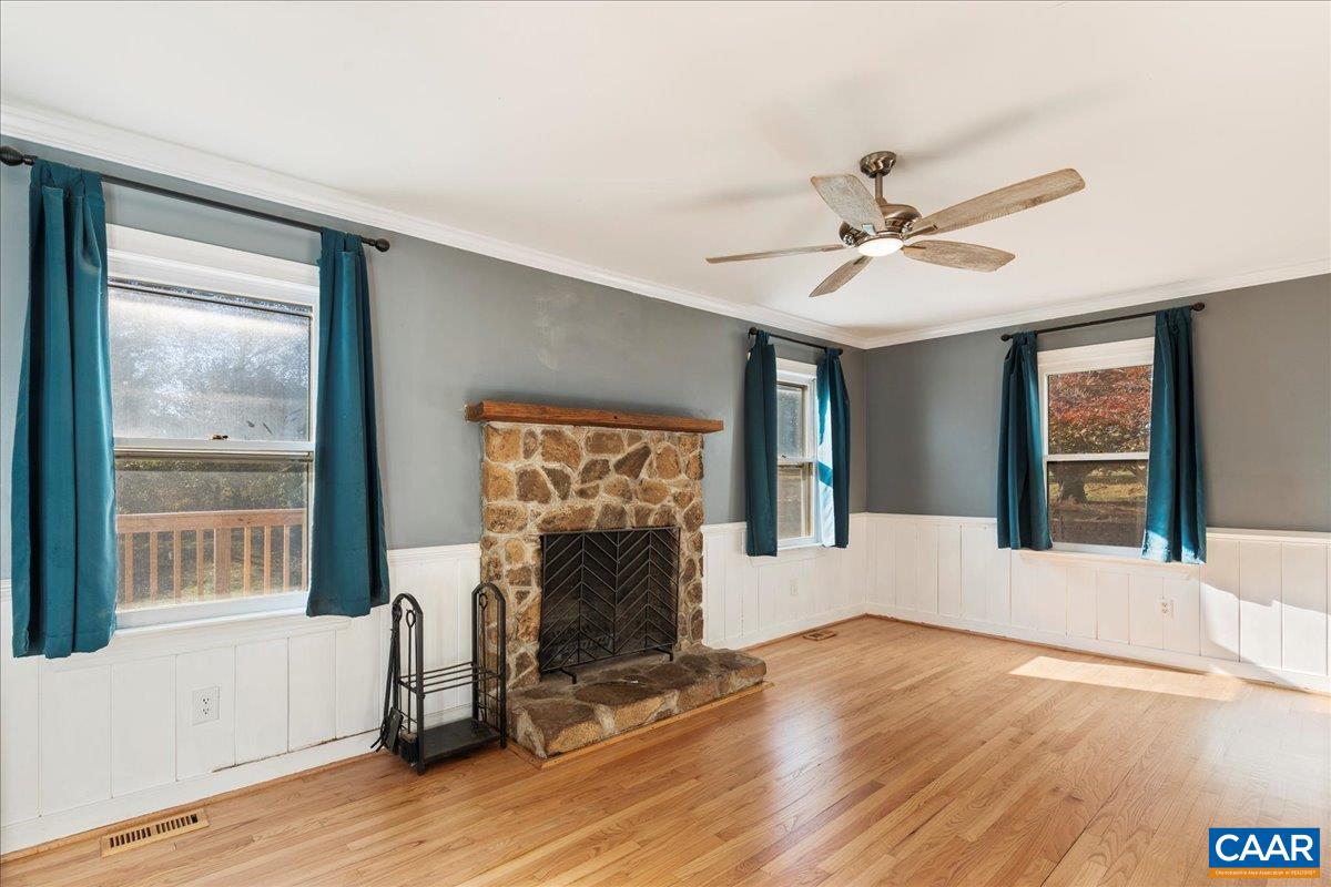 555 Gillums Ridge Road Charlottesville, VA 22903 - Photo 17 of 66 a view of an empty room with window and wooden floor