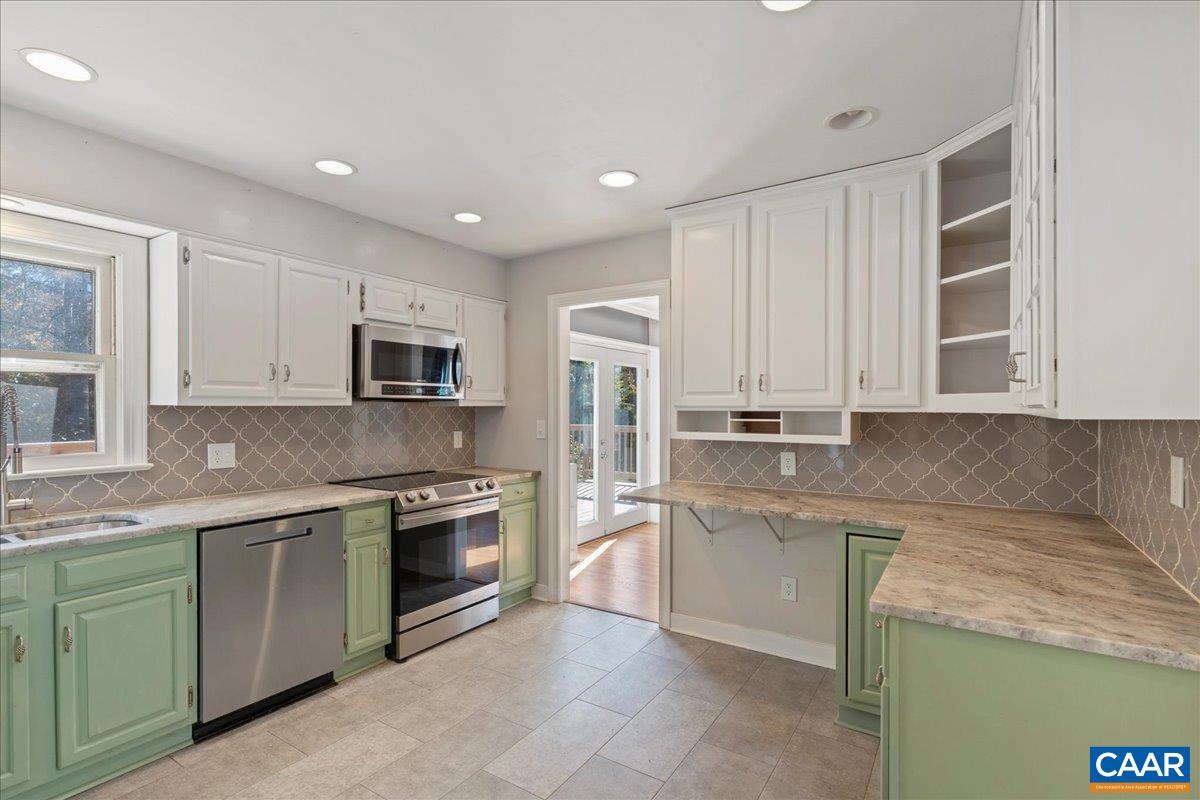 555 Gillums Ridge Road Charlottesville, VA 22903 - Photo 24 of 66 a kitchen with stainless steel appliances granite countertop a stove sink and cabinets