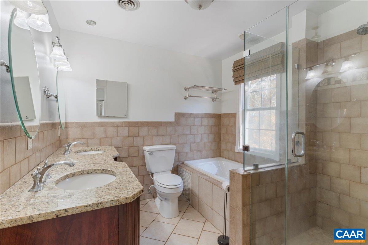 555 Gillums Ridge Road Charlottesville, VA 22903 - Photo 32 of 66 a bathroom with a sink toilet and shower