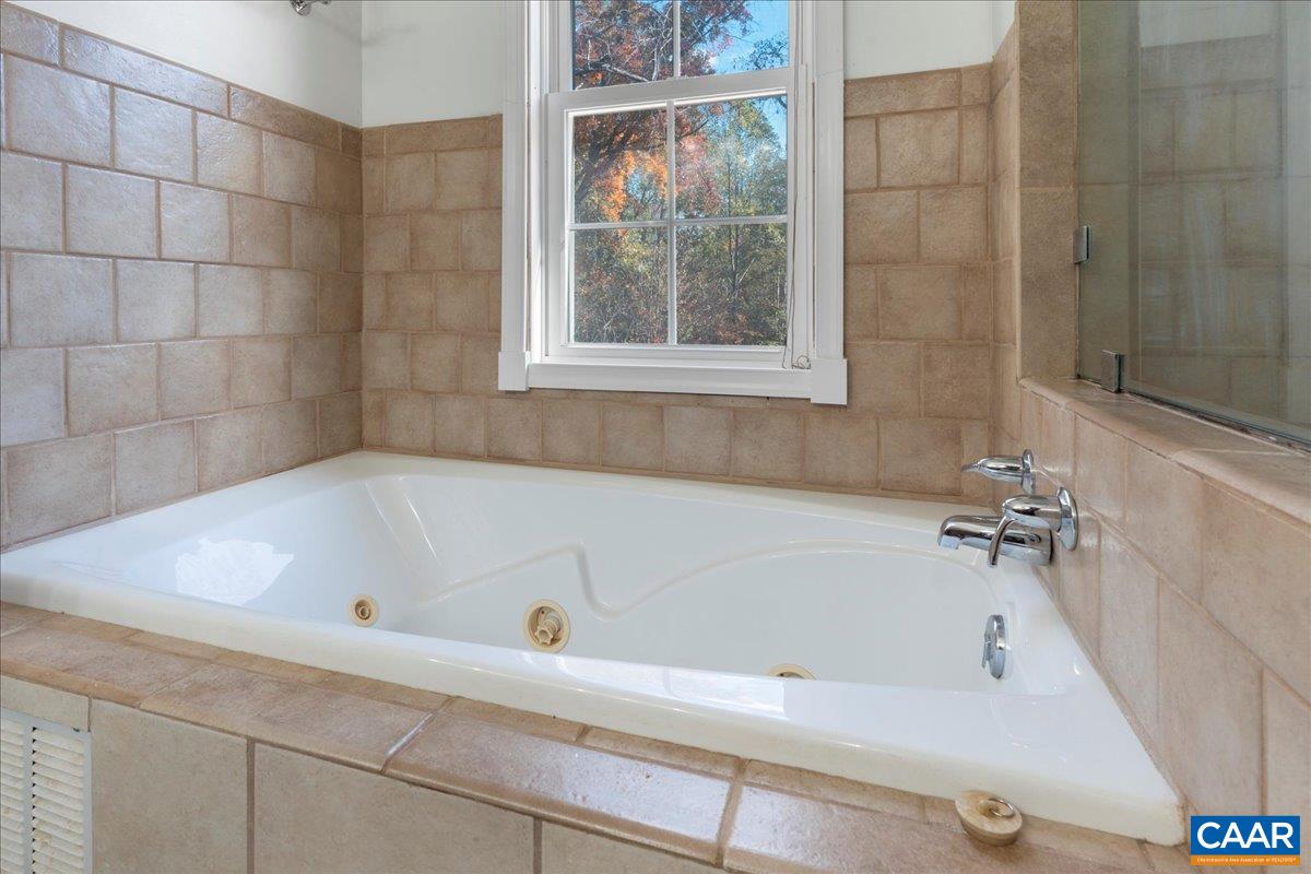 555 Gillums Ridge Road Charlottesville, VA 22903 - Photo 35 of 66 a bathroom with a tub and a shower