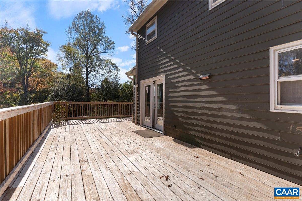 555 Gillums Ridge Road Charlottesville, VA 22903 - Photo 55 of 66 a view of backyard with wooden deck and trees