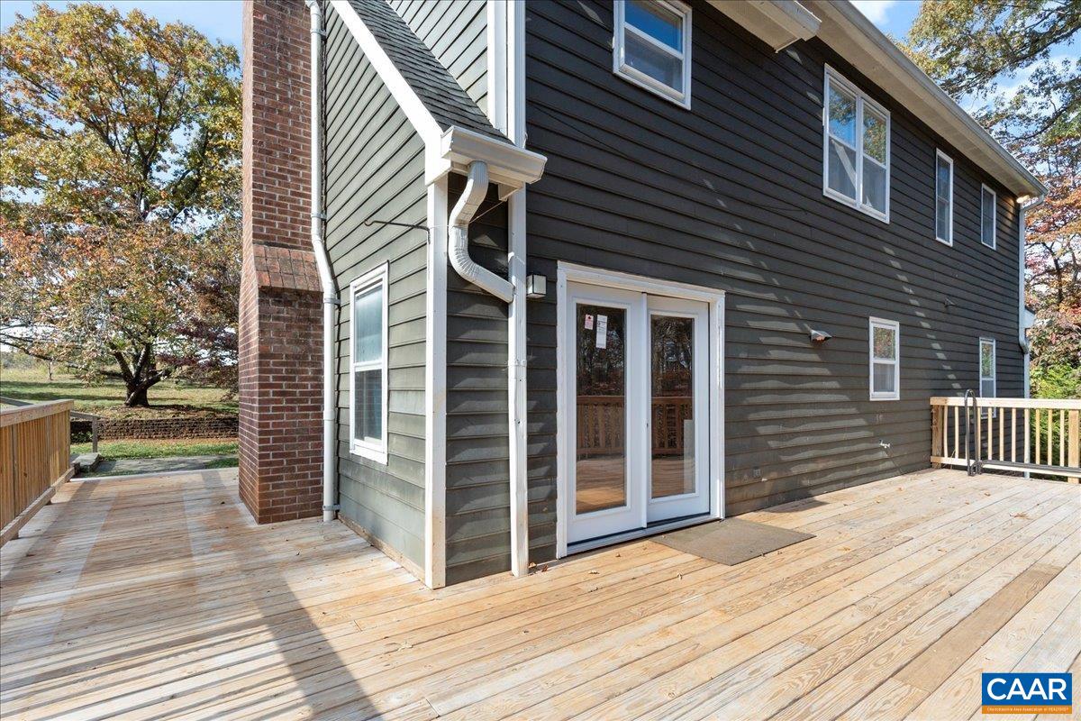 555 Gillums Ridge Road Charlottesville, VA 22903 - Photo 56 of 66 a backyard of a house with wooden floor and fence