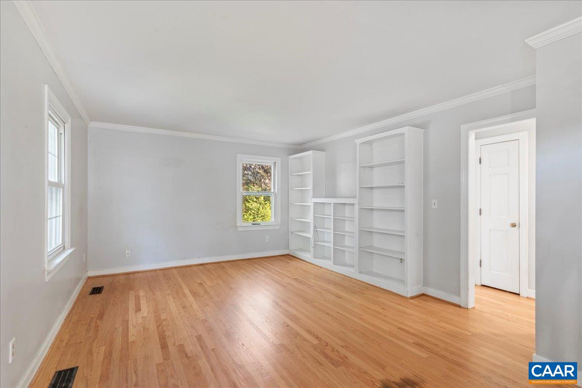 555 Gillums Ridge Road Charlottesville, VA 22903 - Photo 8 of 66 an empty room with wooden floor and windows