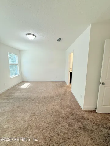 a view of a big room with windows and closet