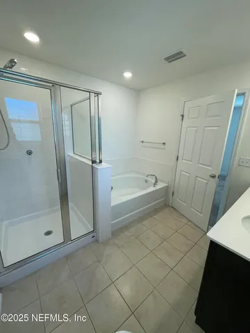 a bathroom with a tub and a shower