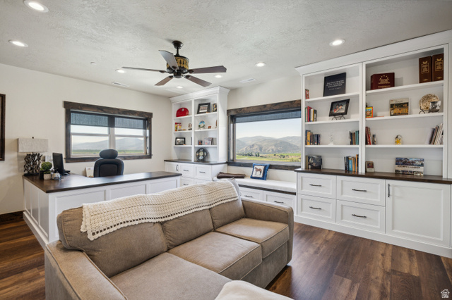 6117 North Rocky Ridge Road Peoa, UT 84061 - Photo 52 of 82 Room featuring wood-finish flooring, built-in white cabinetry with contrasting dark countertops, recessed lighting, and a ceiling fan