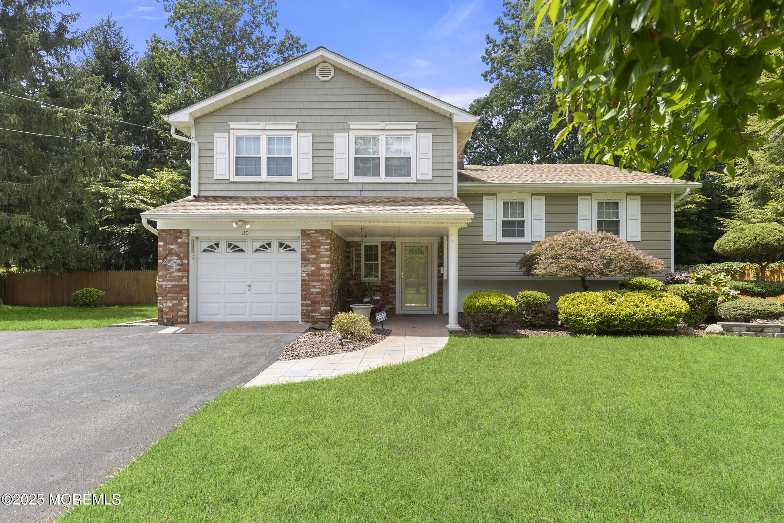 a front view of a house with a garden and yard