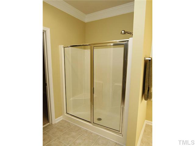 3805 Cathedral Bell Road Raleigh, NC 27614 - Photo 16 of 24 Oversized walk-in shower with bench seat, perfect for a busy day prep or luxury relaxation.