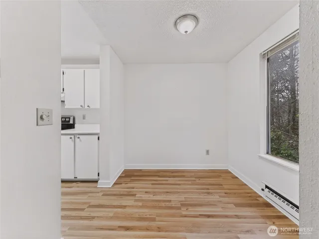 a view of empty room with wooden floor