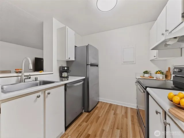a kitchen with a sink appliances and cabinets