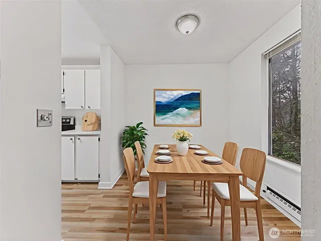 a view of a dining room with furniture and wooden floor