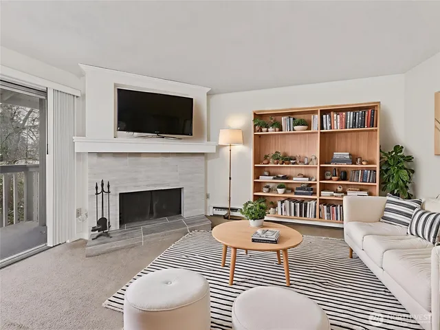 a living room with furniture fireplace and flat screen tv