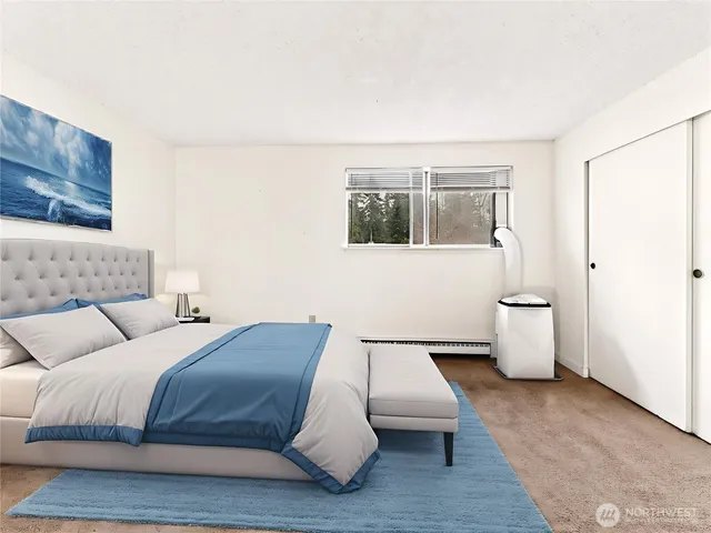 a bedroom with a bed and painting on the wall