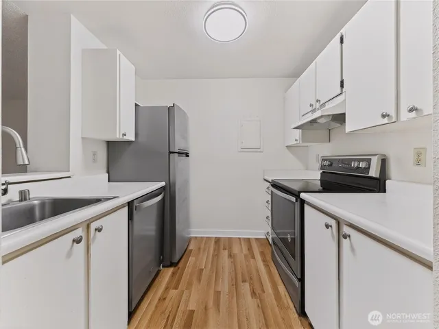 a kitchen that has a sink and a stove in it