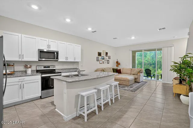 a kitchen with a stove a sink and a refrigerator