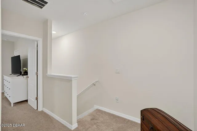 a view of bedroom with furniture and flat screen tv