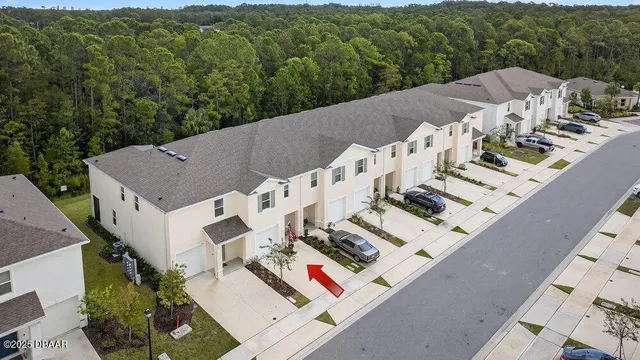 an aerial view of a house with a yard