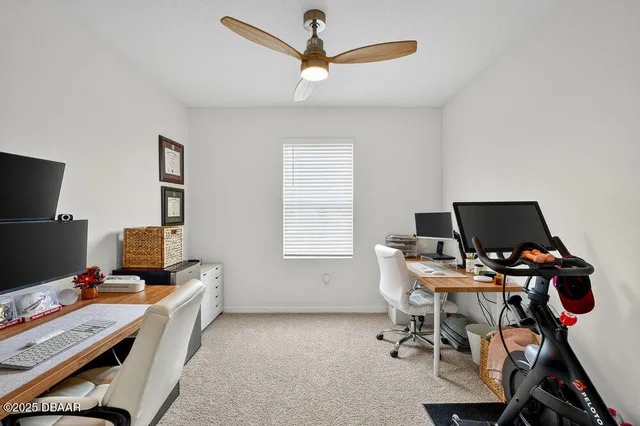 a workspace with furniture and ceiling fan