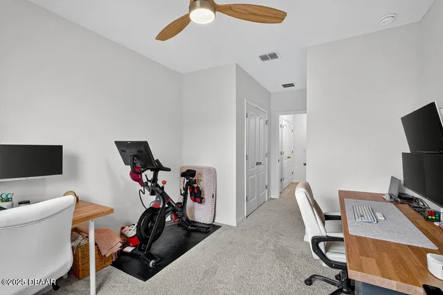 a view of a workspace with furniture and a flat screen tv