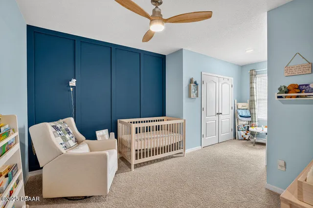 a living room with furniture and a ceiling fan