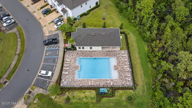 an aerial view of a house with swimming pool