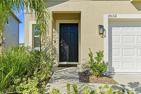 a couple of potted plants in front of door
