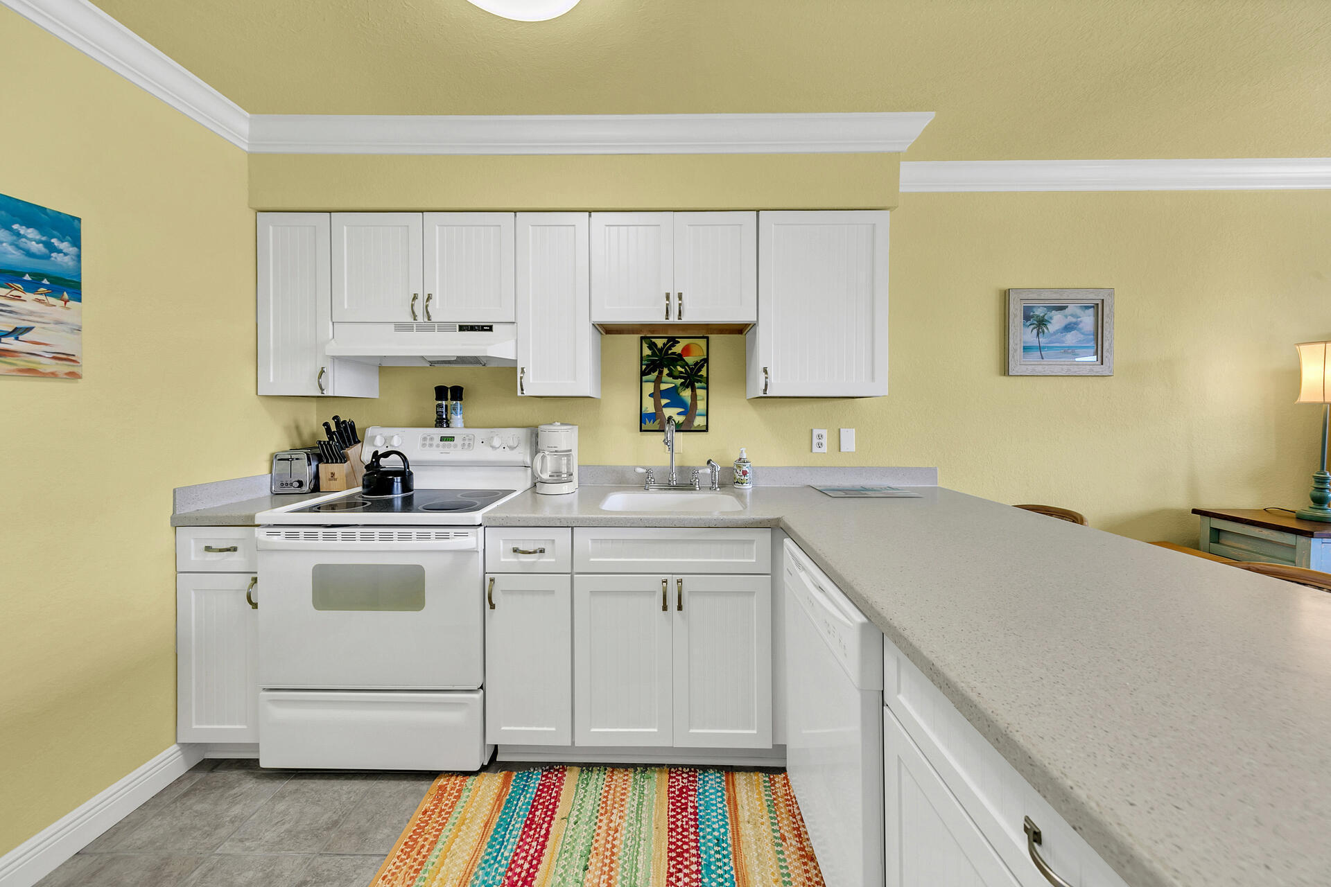 145 Beachfront Trail, Unit 202 Santa Rosa Beach, FL 32459 - Photo 11 of 26 a kitchen with a sink stove and cabinets