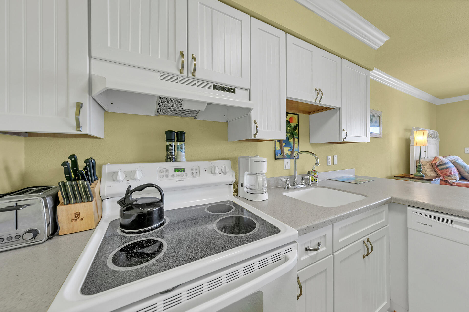 145 Beachfront Trail, Unit 202 Santa Rosa Beach, FL 32459 - Photo 12 of 26 a kitchen with kitchen island white cabinets and white appliances