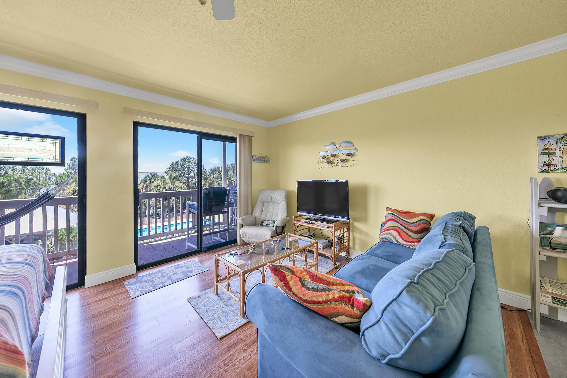 145 Beachfront Trail, Unit 202 Santa Rosa Beach, FL 32459 - Photo 13 of 26 a living room with furniture a flat screen tv and a floor to ceiling window