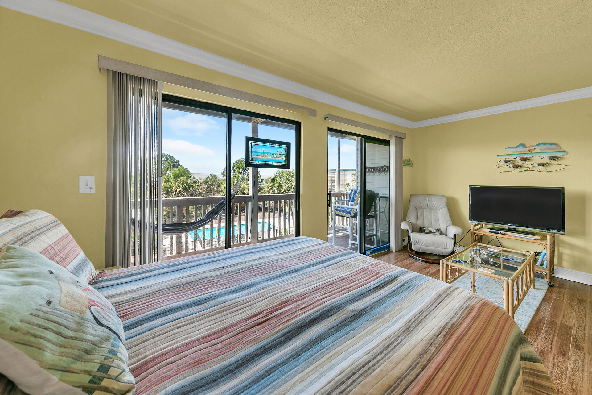 145 Beachfront Trail, Unit 202 Santa Rosa Beach, FL 32459 - Photo 16 of 26 a bedroom with a bed and a flat screen tv