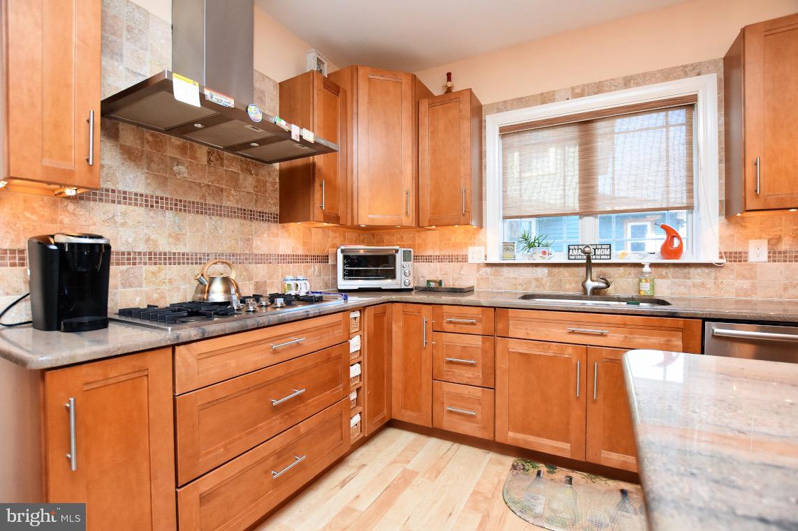 1023 Prospect Ridge Boulevard Haddon Heights, NJ 08035 - Photo 16 of 44 a kitchen with stainless steel appliances granite countertop a sink a stove and cabinets