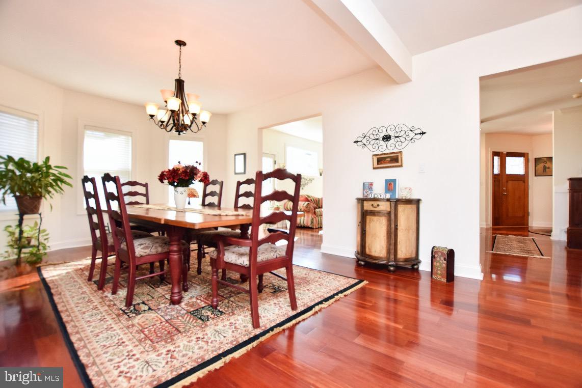 1023 Prospect Ridge Boulevard Haddon Heights, NJ 08035 - Photo 10 of 44 a view of a dining room and livingroom with furniture wooden floor a chandelier