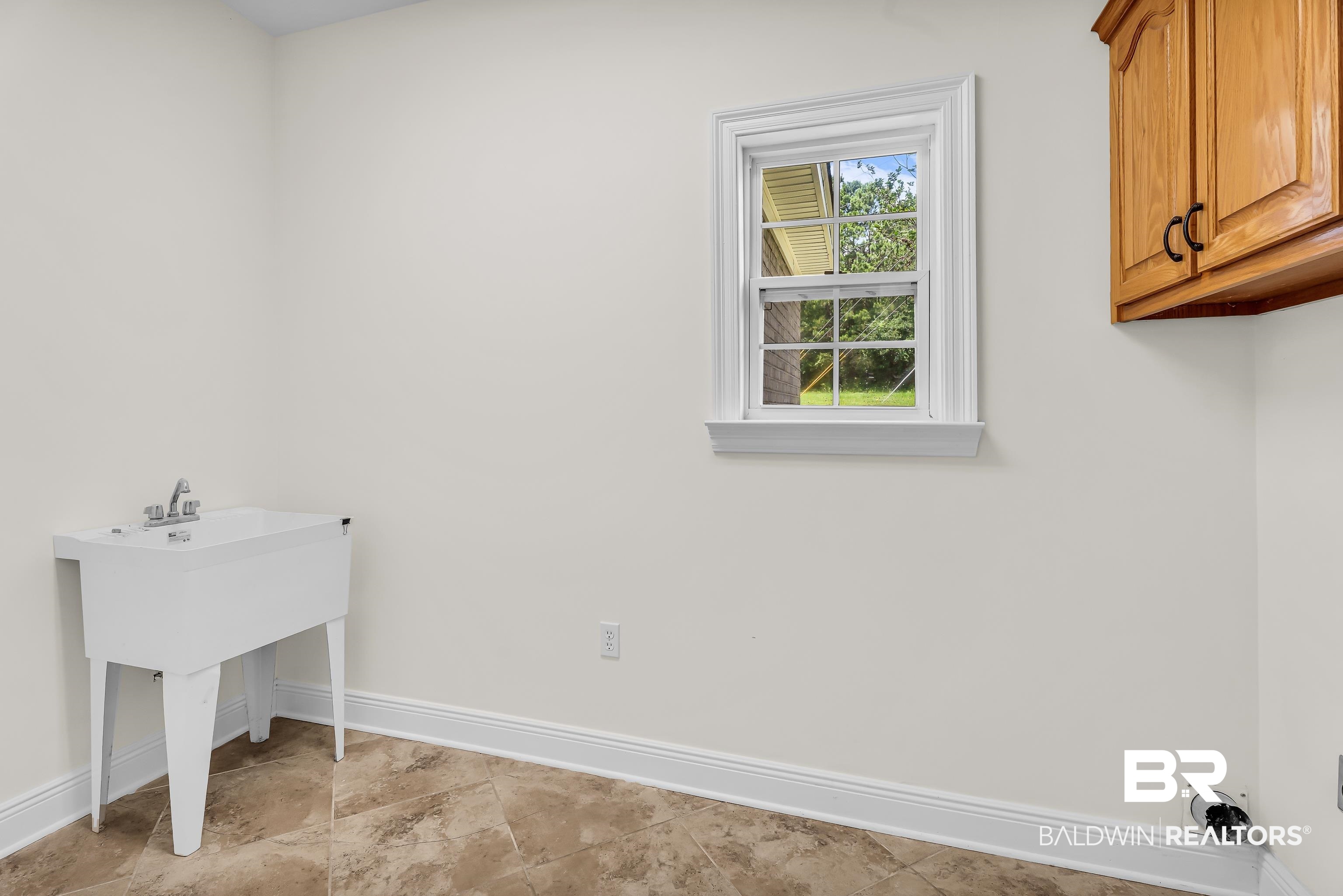 7495 Bromley Road Bay Minette, AL 36507 - Photo 19 of 31 Separate laundry with sink and cabinets