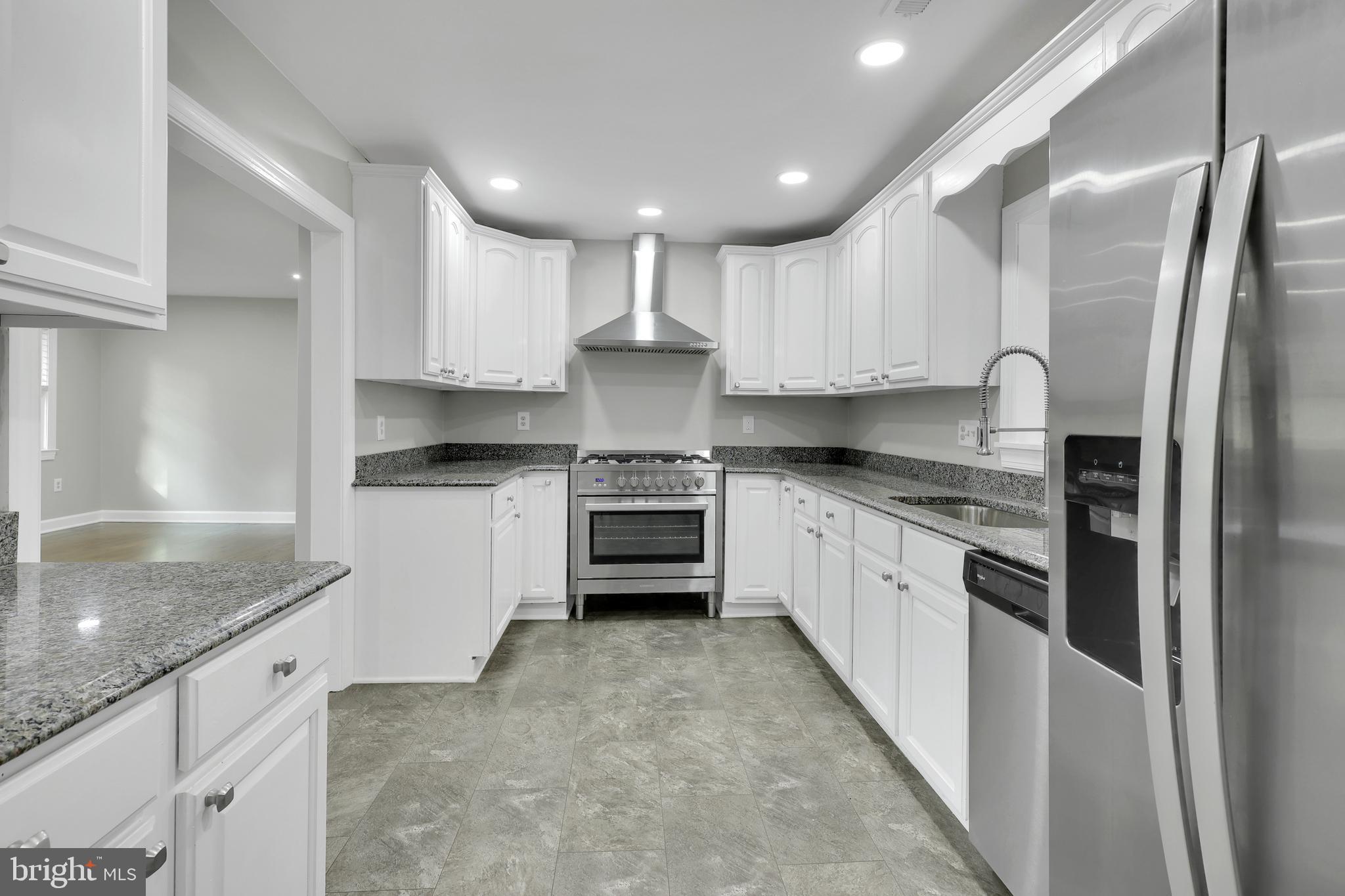 258 Martin Payne Road Kearneysville, WV 25430 - Photo 17 of 35 a kitchen with stainless steel appliances granite countertop a refrigerator sink and cabinets