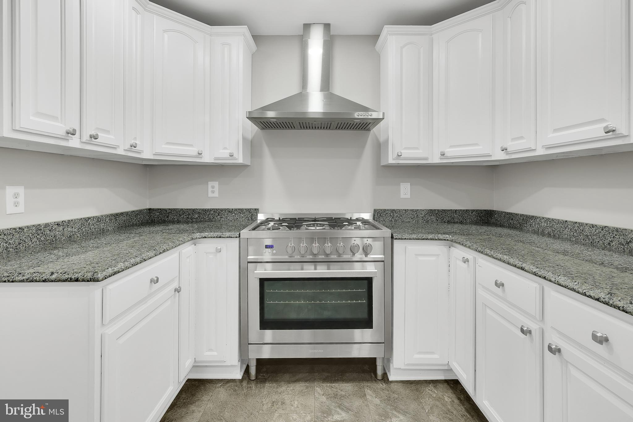 258 Martin Payne Road Kearneysville, WV 25430 - Photo 18 of 35 a kitchen with granite countertop white cabinets and a stove