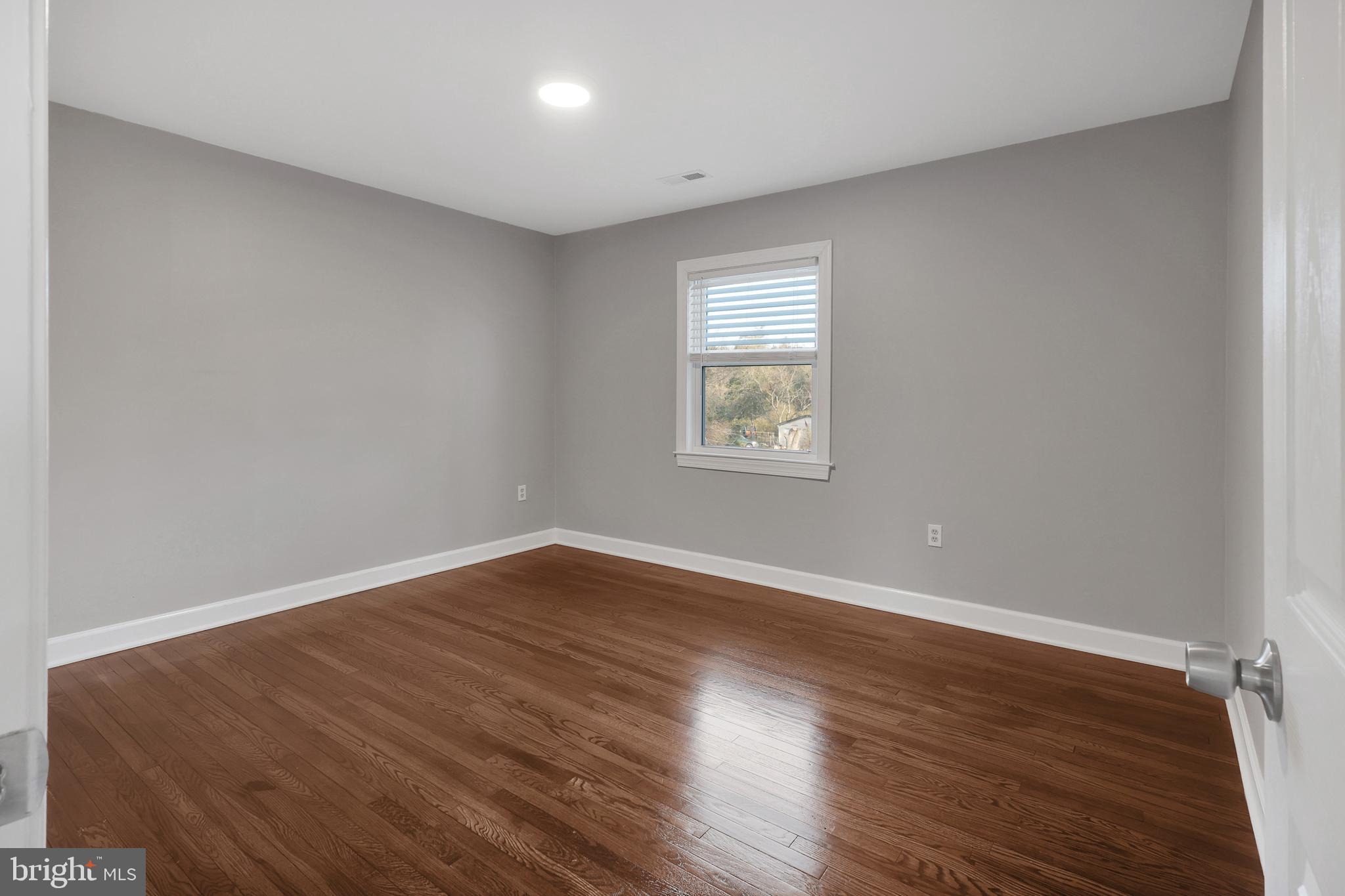 258 Martin Payne Road Kearneysville, WV 25430 - Photo 10 of 35 a view of an empty room with wooden floor and a window