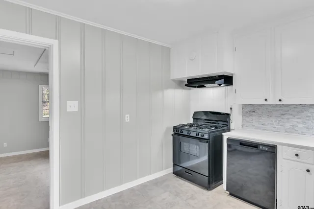a kitchen with granite countertop a stove and a refrigerator