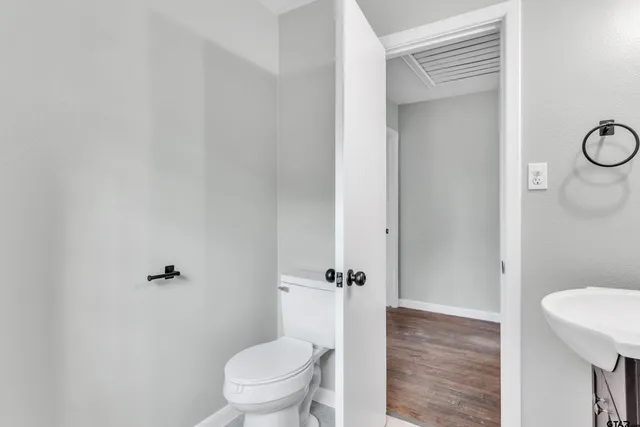 a bathroom with a granite countertop toilet