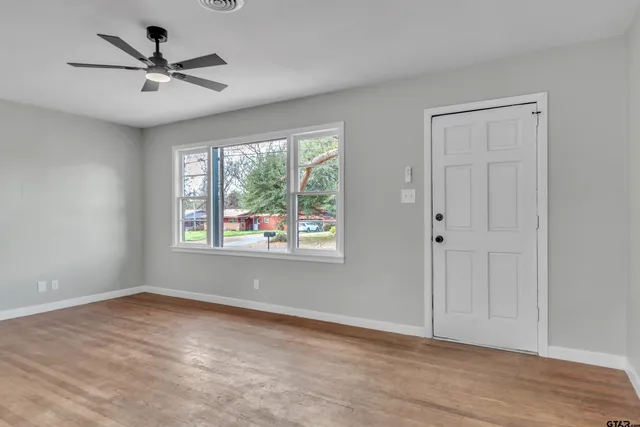a view of a livingroom with a ceiling fan and window