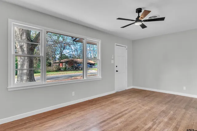 a view of a livingroom with a ceiling fan and window