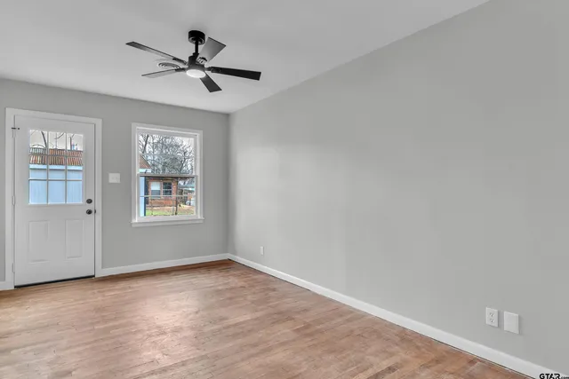 wooden floor in an empty room with a window